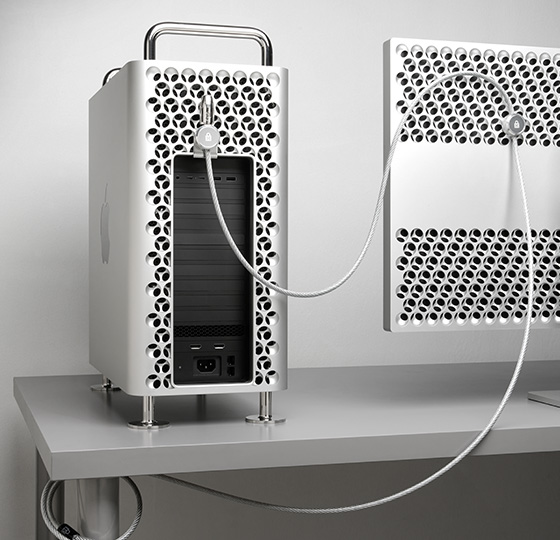 In-use visual of Kensington Mac Pro and Pro Display XDR Locking Kit with cable connected to Mac Pro and Pro Display XDR and wrapped around desk leg.