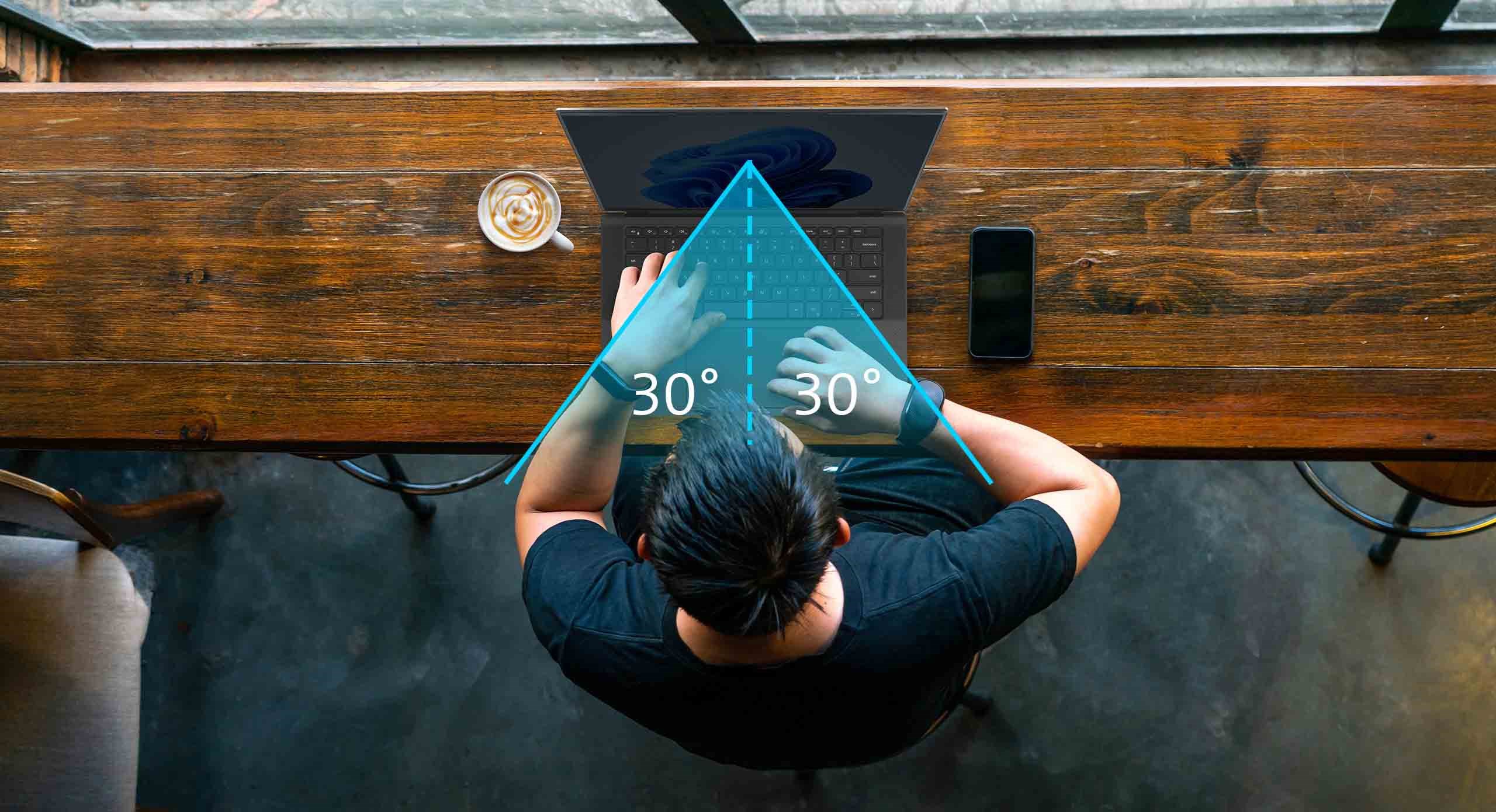 A top view of a person working on their laptop at the coffeeshop illustrating a 30 percent visible screen viewing angle on each side.