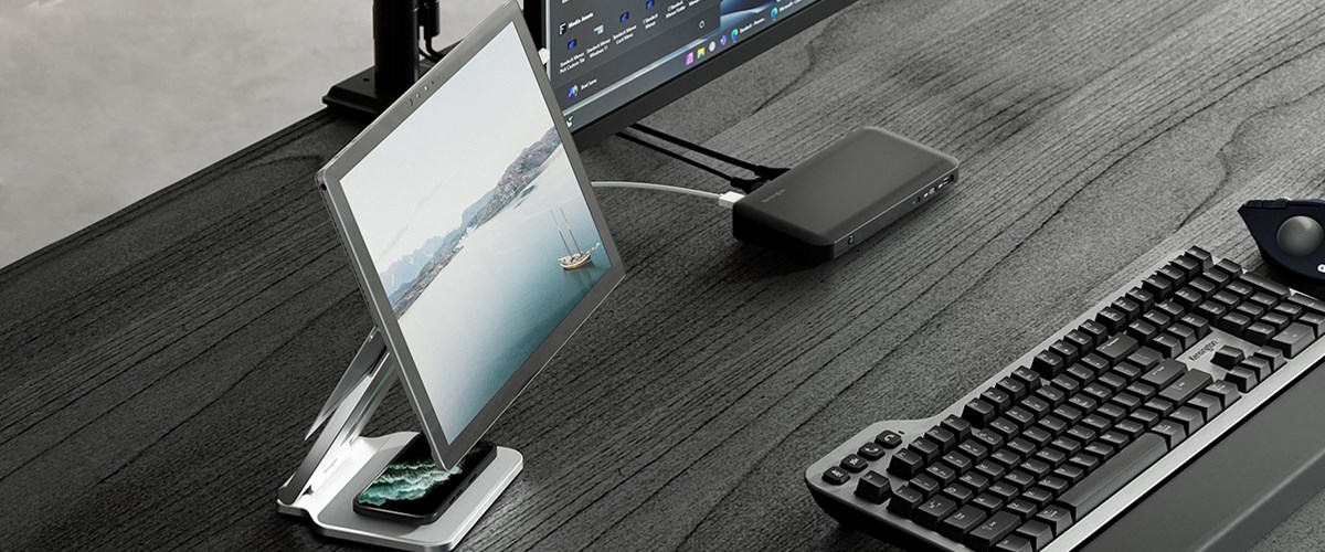 Desksetup featuring a Microsoft Surface device on a Kensington elevated stand, connected to a docking station.