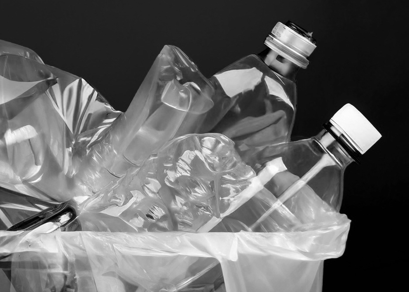 A bunch of plastic bottles inside a trash can.