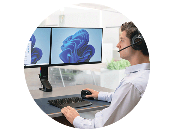 A user sat at the desk using Kensington professional computer accessories