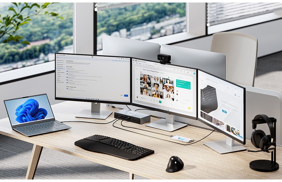 Triple monitor, headphones, and a laptop on a desk all connected to Kensington Thunderbolt docking station.