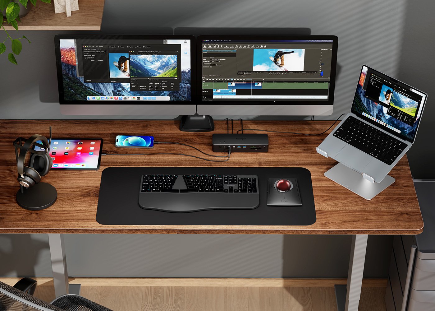 Desk with dual monitor, phone, Ipad, laptop, and headphones all connected to a Kensington docking station.