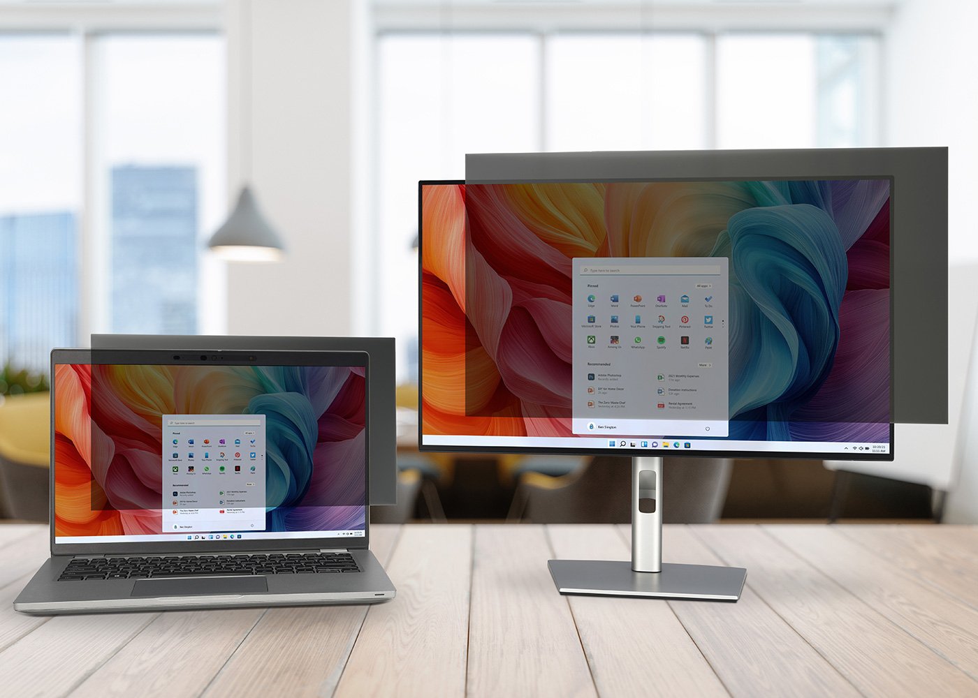Laptop and Desktop on desk both using a Kensington privacy filter.