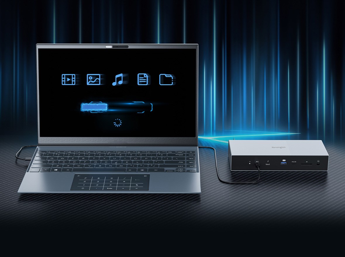 A laptop and a Kensington SD5000T5 EQ Thunderbolt 5 Docking Station on a dark background with blue beams of light. The laptop display shows icons for common multimedia and productivity applications.